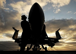 A Sailor cleans the nose of an F/A-18F Super Hornet A Sailor cleans the nose of an F/A-18F Super Hornet