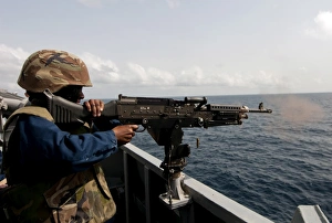 Sailor fires a M240B machine gun aboard USS Winston S. Churchill Sailor fires a M240B machine gun aboard USS Winston S. Churchill