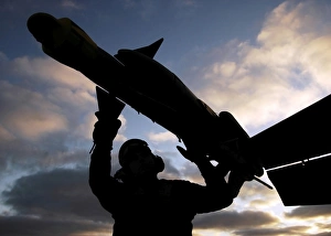 A Sailor inspects a Captive Air Training Missile attached to an F/A-18F Super Hornet A Sailor inspects a Captive Air Training Missile attached to an F/A-18F Super Hornet