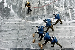 Sailors conduct a Scrub Exercise on the flight deck aboard USS Peleliu Sailors conduct a Scrub Exercise on the flight deck aboard USS Peleliu