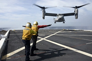 Sailors give an MV-22 Osprey flight directions Sailors give an MV-22 Osprey flight directions