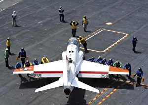 Sailors push a T-45C Goshawk on the flight deck of USS Ronald Reagan Sailors push a T-45C Goshawk on the flight deck of USS Ronald Reagan