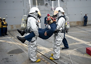 Sailors simulate rescuing a pilot during a crash and salvage drill Sailors simulate rescuing a pilot during a crash and salvage drill