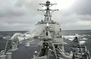 Sea spray whips across the deck of the USS Winston S. Churchill