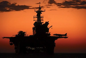 The setting sun silhouettes the amphibious assault ship USS Makin Island The setting sun silhouettes the amphibious assault ship USS Makin Island