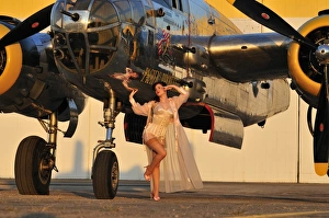 Sexy 1940s pin-up girl in lingerie posing with a B-25 bomber Sexy 1940s pin-up girl in lingerie posing with a B-25 bomber