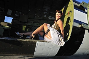 Sexy 1940s style pin-up girl sitting inside of a C-47 Skytrain aircraft Sexy 1940s style pin-up girl sitting inside of a C-47 Skytrain aircraft