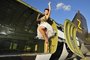 Sexy 1940s style pin-up girl standing inside of a C-47 Skytrain aircraft Sexy 1940s style pin-up girl standing inside of a C-47 Skytrain aircraft