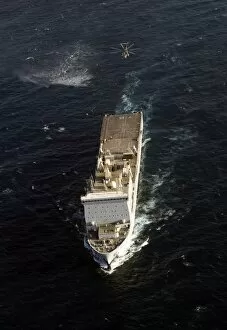 An SH-60 Sea Hawk approaches the Royal Navy landing ship dock RFA Lyme Bay