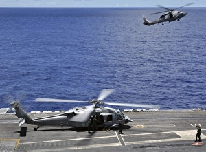 SH-60 Sea Hawk helicopters land aboard the aircraft carrier USS Ronald Reagan SH-60 Sea Hawk helicopters land aboard the aircraft carrier USS Ronald Reagan