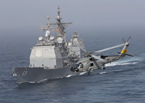 A SH-60J Seahawk flys by USS Vicksburg during a vertical replenishment A SH-60J Seahawk flys by USS Vicksburg during a vertical replenishment