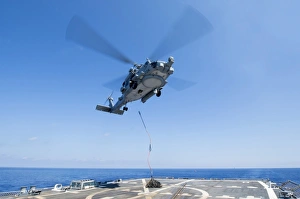 An SH-60R Seahawk delivers supplies during a vertical replenishment An SH-60R Seahawk delivers supplies during a vertical replenishment