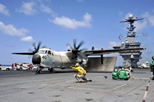 A shooter signals for the launch of a C-2A Greyhound A shooter signals for the launch of a C-2A Greyhound