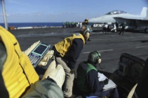 A Shooter tests a catapult capacity selector valve calculator during flight operations A Shooter tests a catapult capacity selector valve calculator during flight operations