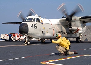 Signalman gives the launch signal to a C-2A Greyhound Signalman gives the launch signal to a C-2A Greyhound