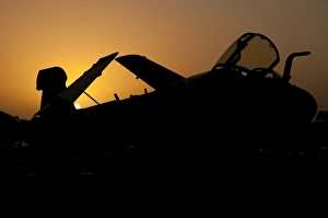 Silhouette of an EA-6B Prowler at sunrise on the flight deck of USS Nimitz Silhouette of an EA-6B Prowler at sunrise on the flight deck of USS Nimitz