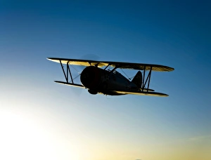 Silhouette of a Grumman F3F biplane in flight Silhouette of a Grumman F3F biplane in flight