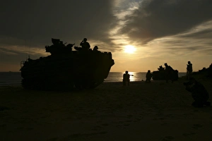 Silhouette of Marines and an amphibious assault vehicle providing security on Hwajin Beach Silhouette of Marines and an amphibious assault vehicle providing security on Hwajin Beach