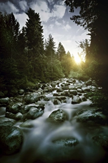 Small river flowing over large stones at sunset, Pirin National Park, Bulgaria Small river flowing over large stones at sunset, Pirin National Park, Bulgaria