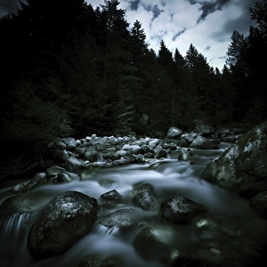 Small river flowing over stones covered with moss, Pirin National Park, Bulgaria Small river flowing over stones covered with moss, Pirin National Park, Bulgaria