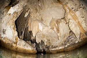 Snorkeler explores the spectacular Tomolol caves, Raja Ampat Snorkeler explores the spectacular Tomolol caves, Raja Ampat