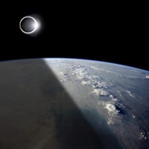 A solar eclipses partially shades the Earth below A solar eclipses partially shades the Earth below