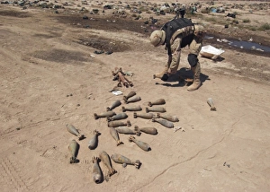 Soldier moves 82mm mortars to a safer place for demolition Soldier moves 82mm mortars to a safer place for demolition