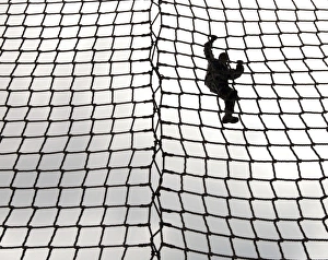A soldier in training makes her way down the rope ladder at Victory Tower A soldier in training makes her way down the rope ladder at Victory Tower