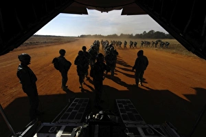Soldiers board a C-130 Hercules during Operation Toy Drop Soldiers board a C-130 Hercules during Operation Toy Drop