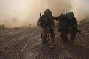 Soldiers brace for the impact of a cloud of sand and rocks from a landing CH-53 Super Soldiers brace for the impact of a cloud of sand and rocks from a landing CH-53 Super