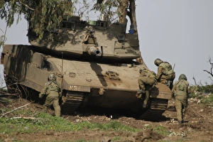 Soldiers climb into an Israel Defense Force Merkava Mark IV battle tank Soldiers climb into an Israel Defense Force Merkava Mark IV battle tank