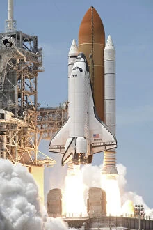 Complex Collection: Space shuttle Atlantis twin solid rocket boosters ignite to propel the spacecraft