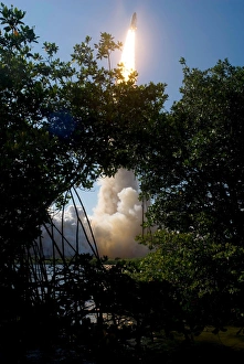 Space Shuttle Discovery lifts off, framed by Florida foliage Space Shuttle Discovery lifts off, framed by Florida foliage