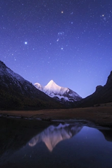 Starry sky at the break of dawn over Mt. Jampayang in China Starry sky at the break of dawn over Mt. Jampayang in China