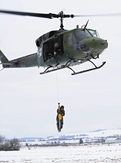 A student is hoisted into a UH-1N Iroquois during a training exercise A student is hoisted into a UH-1N Iroquois during a training exercise