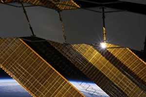 The sun shines through the solar panels on the International Space Station The sun shines through the solar panels on the International Space Station