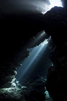 Sunlight descends underwater and into a crevice in a reef in the Solomon Islands Sunlight descends underwater and into a crevice in a reef in the Solomon Islands