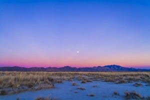 Sunset and gibbous moon above the Chiricahua Mountains in Arizona Sunset and gibbous moon above the Chiricahua Mountains in Arizona