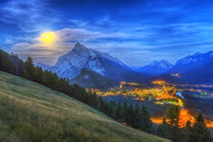 Supermoon rising over Mount Rundle and Banff townsite in Canada Supermoon rising over Mount Rundle and Banff townsite in Canada