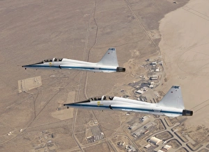 Two T-38A mission support aircraft fly in tight formation Two T-38A mission support aircraft fly in tight formation