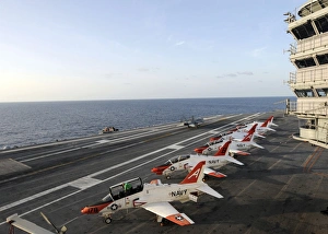 T-45C Goshawk training aircraft line the flight deck aboard the aircraft carrier USS T-45C Goshawk training aircraft line the flight deck aboard the aircraft carrier USS