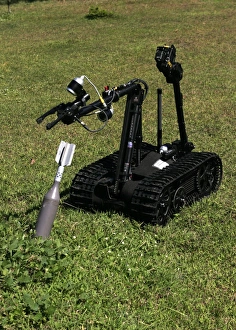 The Talon bomb disposal robot picks up an inert unexploded mortar round The Talon bomb disposal robot picks up an inert unexploded mortar round