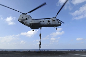 A trio of Marines fast rope from a CH-46E Sea Knight helicopter A trio of Marines fast rope from a CH-46E Sea Knight helicopter