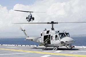 A UH-1N Huey and an AH-1W Super Cobra land on flight deck of USS Essex A UH-1N Huey and an AH-1W Super Cobra land on flight deck of USS Essex