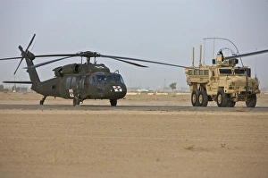 A UH-60 Black Hawk medevac helicopter and a RG-33 MRAP A UH-60 Black Hawk medevac helicopter and a RG-33 MRAP