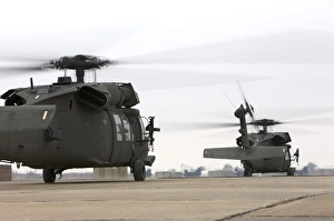Two UH-60 Black Hawks taxi out for a mission over northern Iraq Two UH-60 Black Hawks taxi out for a mission over northern Iraq