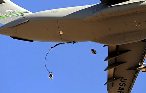 U.S Air Force Airmen parachute into a drop zone from a C-17 Globemaster III
