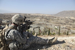 U.S Army soldier scans his sector of fire with his M14 rifle in Afghanistan U.S Army soldier scans his sector of fire with his M14 rifle in Afghanistan