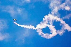 A U.S. Navy Parachute Team Leap Frogs crewmember descends through the sky