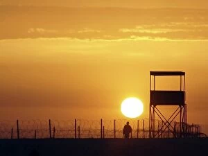 Images Dated 25th March 2004: A U.S. Soldier provides protection as the sun rises above the Iraqi desert